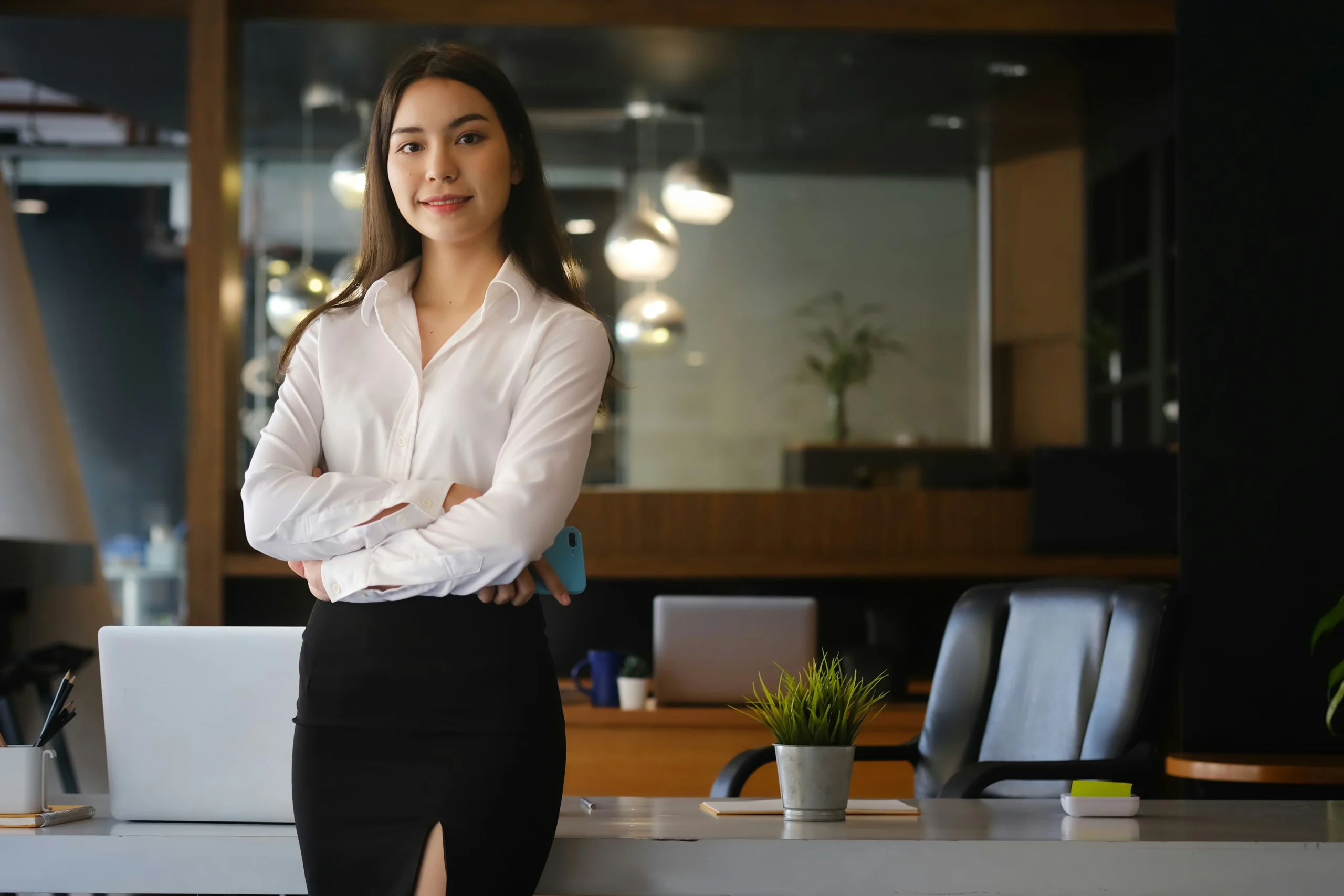 business woman crossing her arms outside of her office